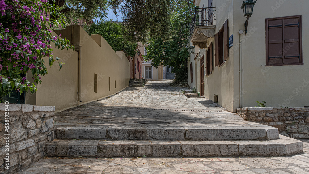 Intimate, tranquil  and sunlit street located at the foothill of Acropolis, Athens, Greece. 
