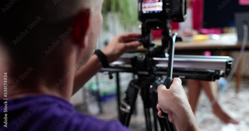A male cameraman filming a woman in the office, close-up A male cameraman filming a woman in the office, close-up
