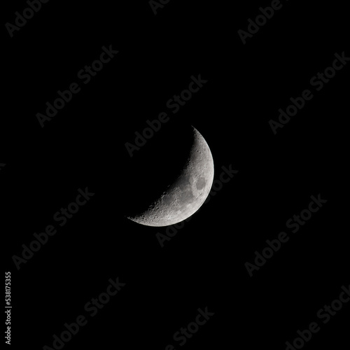 Crescent moon shining bright in the dark night sky 