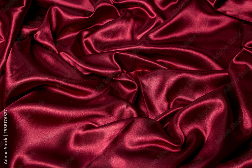 Crumpled red fabric as a background for the image. Texture of red textile material Crumpled red fabric as a background for the image. Texture of red textile material