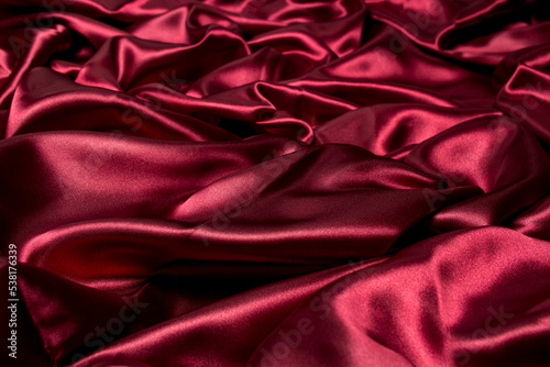 Crumpled red fabric as a background for the image. Texture of red textile material