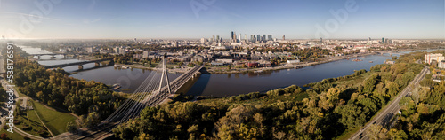 Aerial view on a sunny ,autumn day on the center of Warsaw ,skyscrapers ,financial centers and the Vistula River and bridges on it. © Zdzislaw