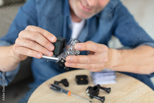craftsman repairs video camera with screwdriver