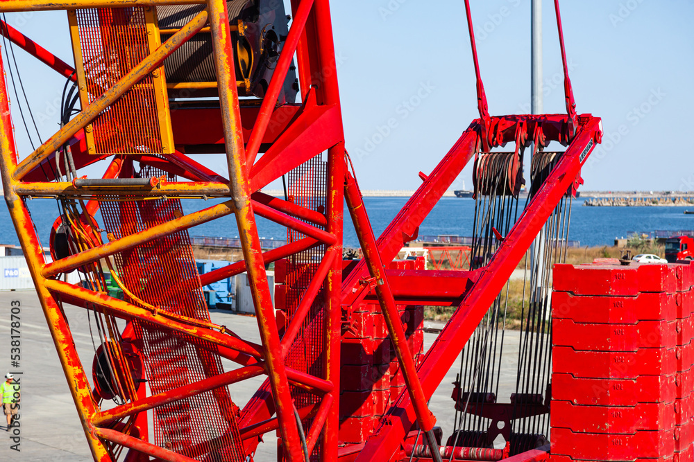 Large port crane on a wheeled chassis in the port area, close-up.