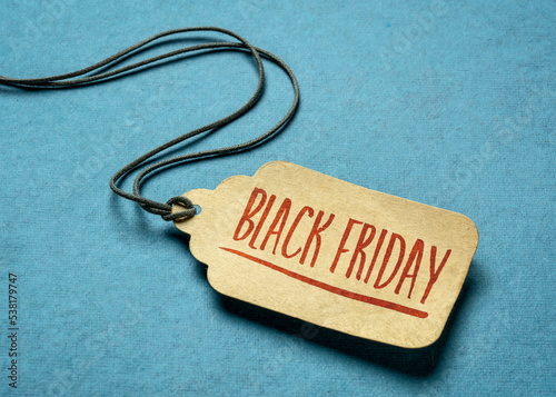 Black Friday sign - a paper price tag with a twine against texture paper, fall holidays and shopping concept