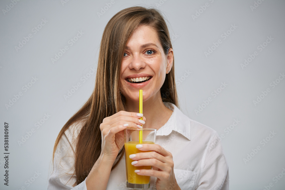 Smiling woman holding orange juicy drink. Isolated female advertising portrait. Smiling woman holding orange juicy drink. Isolated female advertising portrait.
