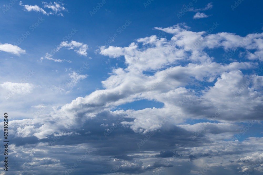 white fluffy clouds on blue sky in summer.