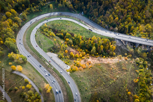 bird's-eye view of the road with an autumn forest and a road slot.