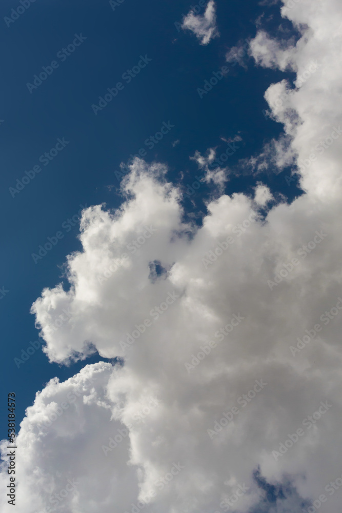 Fluffy cumulus clouds in sunny day. Atmosphere dark blue background or wallpaper Fluffy cumulus clouds in sunny day. Atmosphere dark blue background or wallpaper