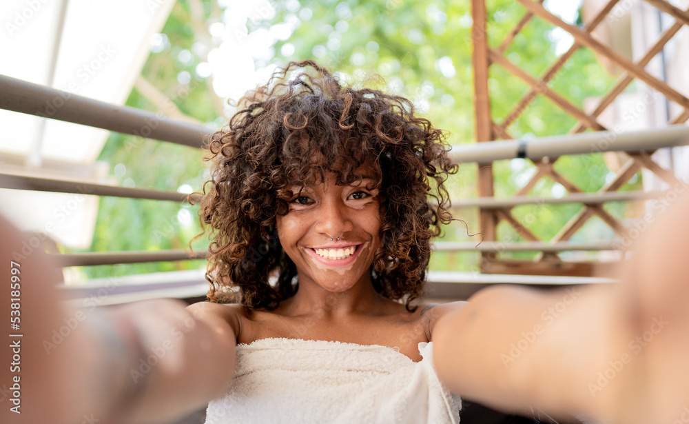 Attractive african girl with vitiligo taking a selfie at spa - Beauty treatment and leisure concept Attractive african girl with vitiligo taking a selfie at spa - Beauty treatment and leisure concept