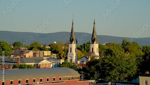 View of church spires in Frederick, Maryland with a hill and the sky in the background. photo
