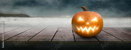 spooky pumpkin on a halloween night table - copy space