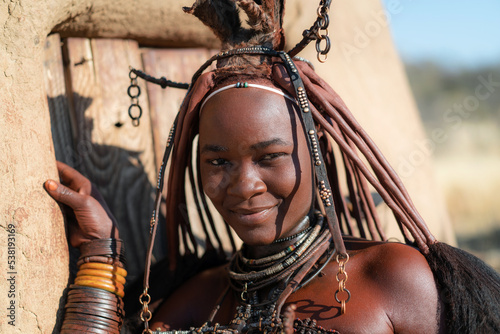 Young Himba woman dressed in traditional style in Namibia, Africa.