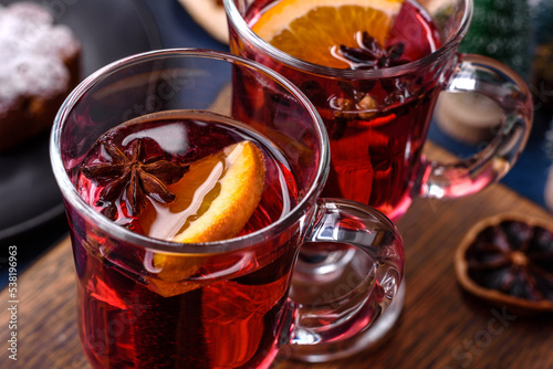 Hot mulled wine with a slice of orange, with cinnamon, cloves and other spices