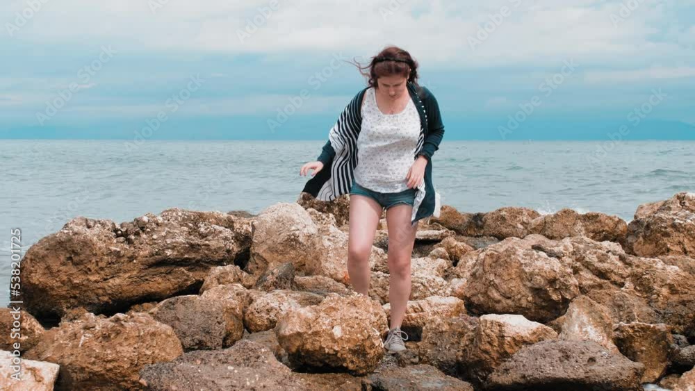 Wonderful Woman Walks On Stones Sea And Reacts To Spray Of Waves Wonderful Woman Walks On Stones Sea And Reacts To Spray Of Waves