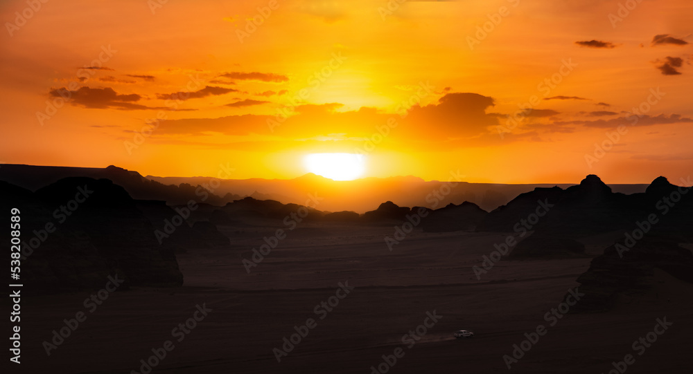A speeding car in the desert at sunset. A speeding car in the desert at sunset.