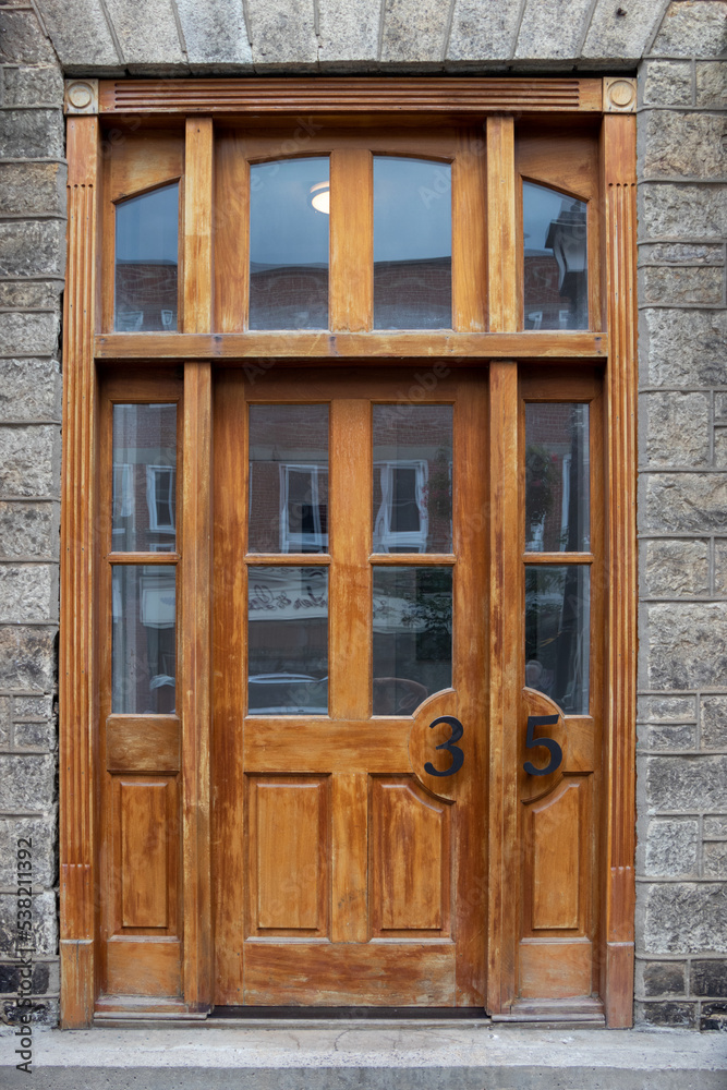 A beautiful wooden door and windows at the entry to a historic building
