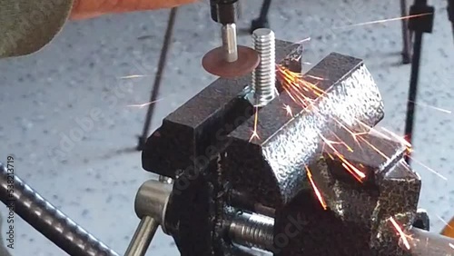 Slow Motion Top View Cutting A Metal Washer With Dremel Tool photo
