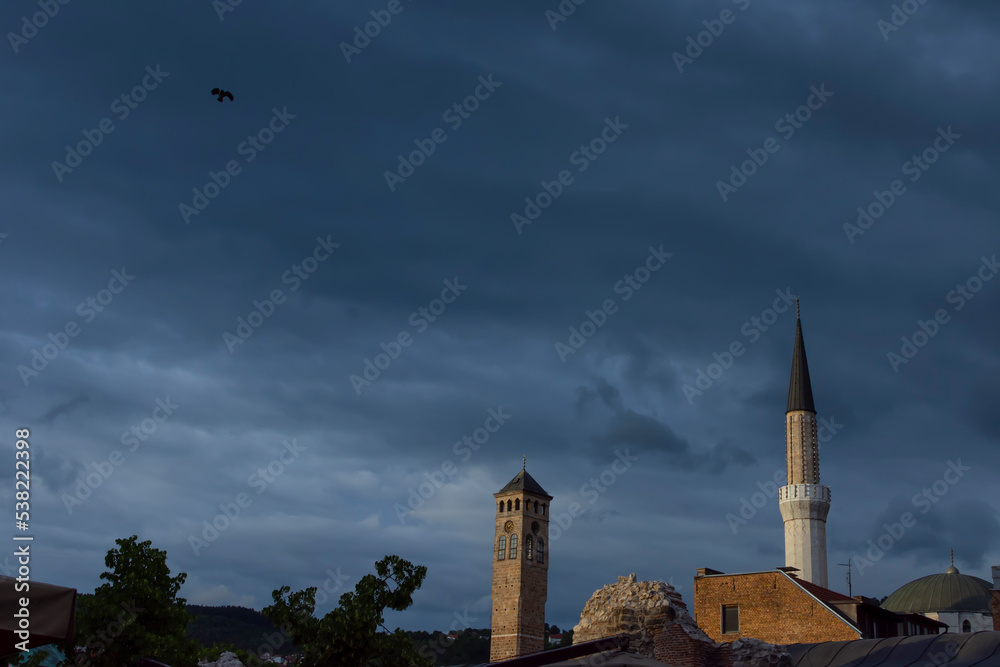 Sarajevo clock tower and minaret of Gazi Husrev bey mosque with taslihan remains and roof of bezistan. Famous historical touristic plac visit located at center of Bascarsija in capital city