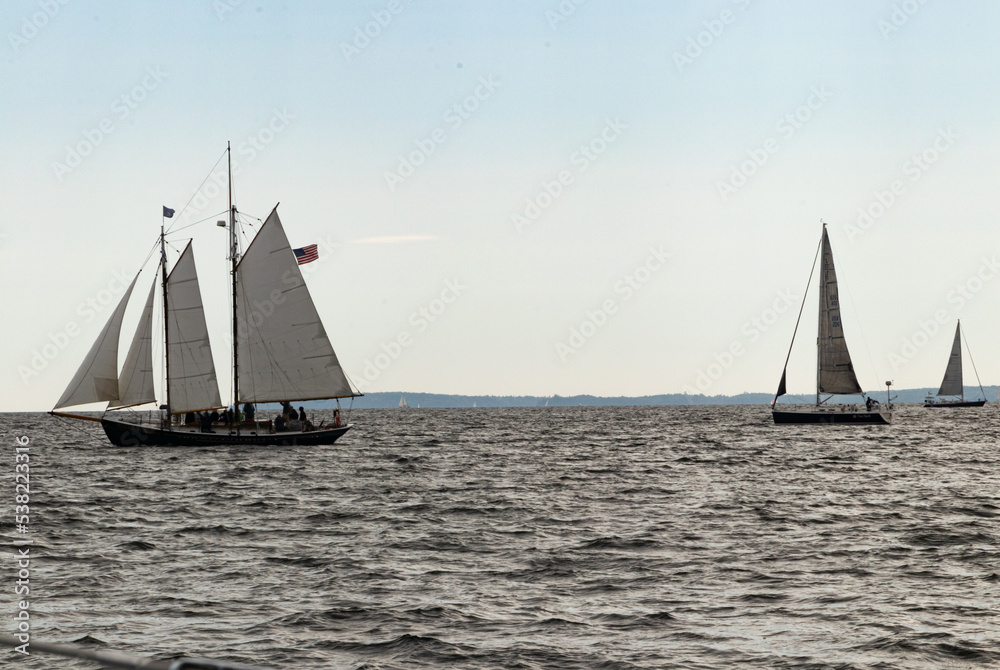 sailboats with 4 sails hoisted on the sea