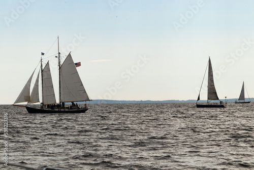 sailboats with 4 sails hoisted on the sea