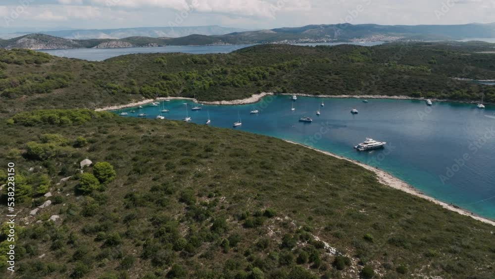 Aerial shot of South Croatian Island bay full of parked sailboats, sunny day