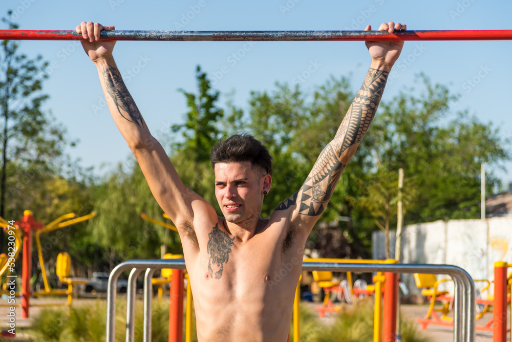 sportsman doing outdoor gymnastics, athlete, calisthenics sportsman doing outdoor gymnastics, athlete, calisthenics