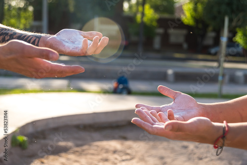 hands with magnes, sportsman doing outdoor gymnastics, athlete, calisthenics photo