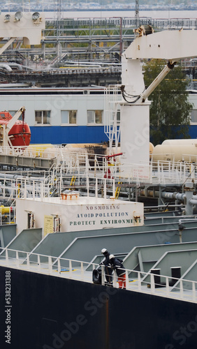 Tallinn, Estonia - 10 03 2022: Seafarers on board the large oil tanker during bunkering operations photo