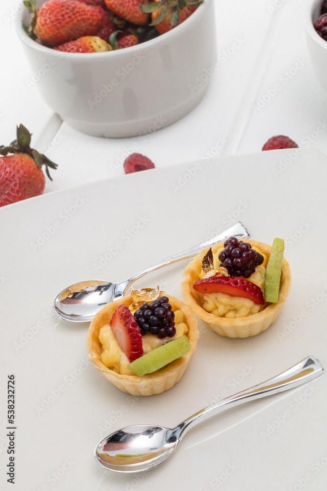 details of dessert decorated with strawberries, blackberries and pastry cream, wallpaper of elegant plates with silver spoons, pastries details of dessert decorated with strawberries, blackberries and pastry cream, wallpaper of elegant plates with silver spoons, pastries