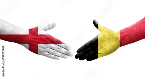 Handshake between Belgium and England flags painted on hands, isolated transparent image.