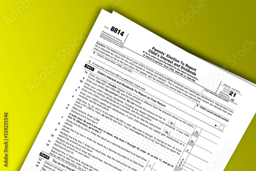 Form 8814 documentation published IRS USA 44207. American tax document on colored