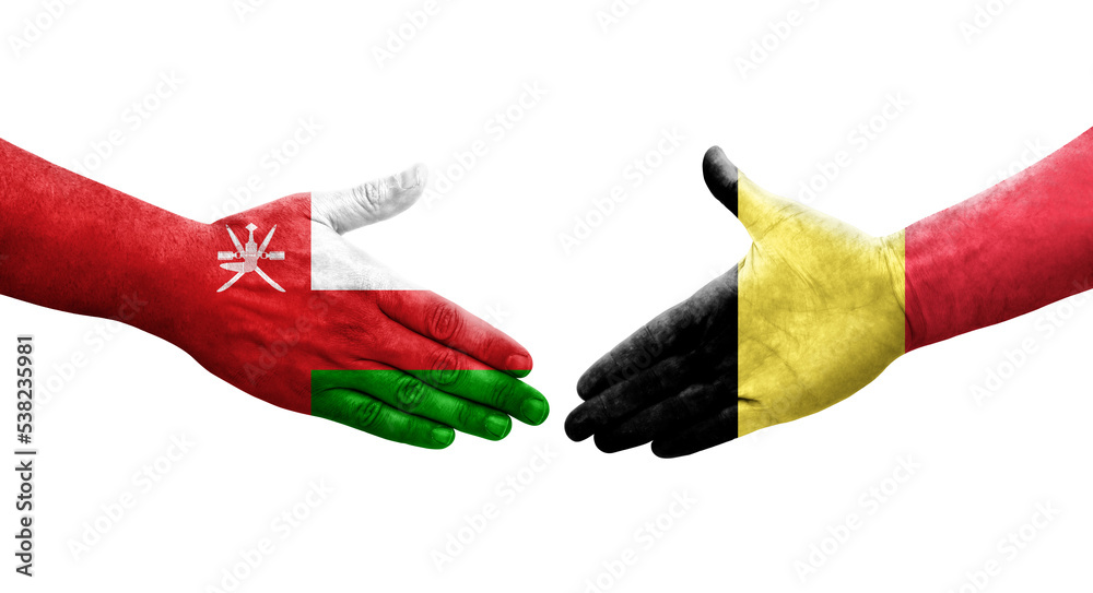 Handshake between Belgium and Oman flags painted on hands, isolated transparent image. Handshake between Belgium and Oman flags painted on hands, isolated transparent image.