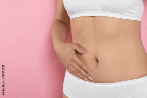Wallpaper Mural Woman in underwear touching her belly on pink background, closeup. Healthy stomach Torontodigital.ca