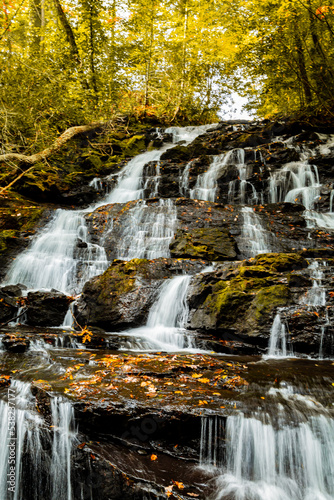 beautiful cascading waterfall in autumn forest at Vogel State Park Georgia, vertical framing