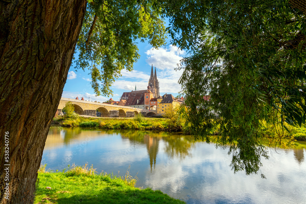 The picturesque skyline including the stone bridge over the Danube River, Saint Peter's Church and Regensburg Town Hall in the Bavarian city of Regensburg, Germany. The picturesque skyline including the stone bridge over the Danube River, Saint Peter's Church and Regensburg Town Hall in the Bavarian city of Regensburg, Germany.