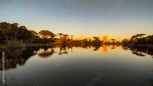 Sunset on the lake with reflection in the water, orange view