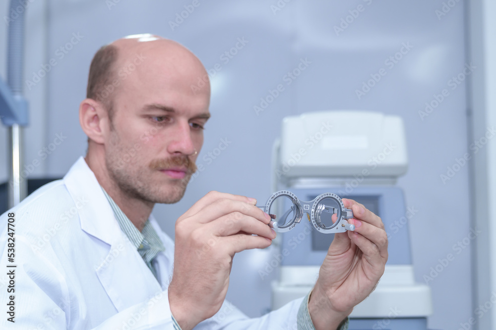 Image of an optometrist holding a messbrille in an ophthalmology clinic. Image of an optometrist holding a messbrille in an ophthalmology clinic.