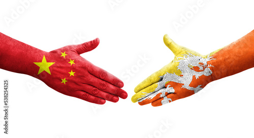 Handshake between Bhutan and China flags painted on hands, isolated transparent image.