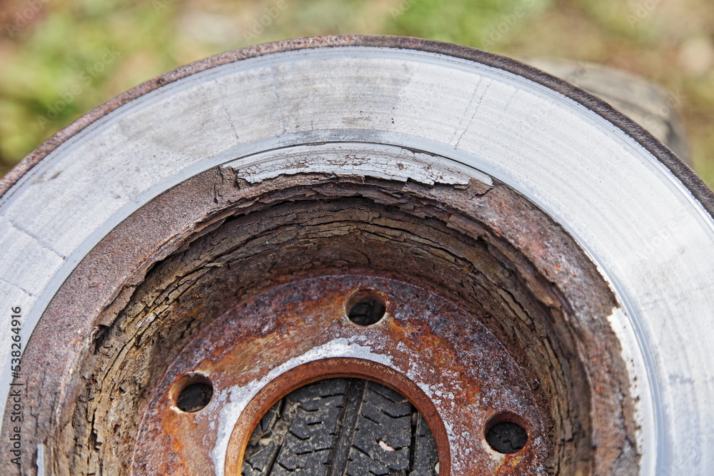 Heavy layered corrosion on ventilated car brake disc surface closeup