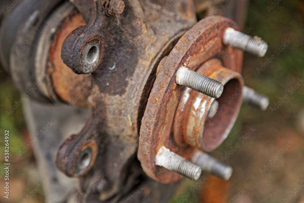 Rusty car front wheel hub without brake disc and support on steering knuckle. Car brakes repair Rusty car front wheel hub without brake disc and support on steering knuckle. Car brakes repair
