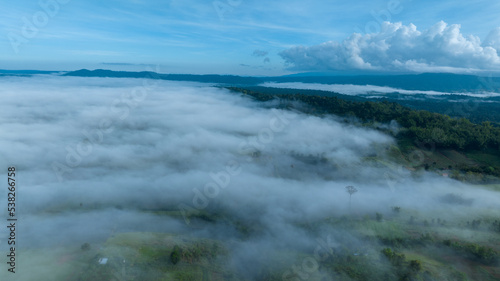 Mountains in fog at beautiful autumn in Phetchabun Thailand. Fog mountain valley, low clouds, forest, colorful sky with. pine trees in spruce foggy forest with bright sunrise