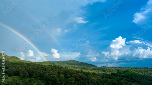 Rainbow on Sky in the mountains, Panorama of flying in a Nature rainbow in the rain, aerial view of Rainbow in mountain , Rainbow in the Mountains Puffy Clouds After the Rain