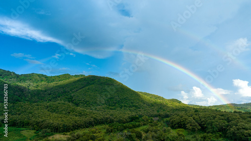 Rainbow on Sky in the mountains, Panorama of flying in a Nature rainbow in the rain, aerial view of Rainbow in mountain , Rainbow in the Mountains Puffy Clouds After the Rain