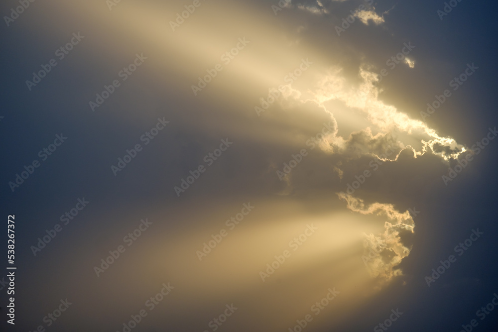 Sun rays emerging from behind a cloud