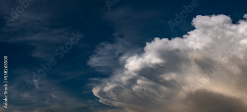 expressive clouds in a dark blue sky © niklan