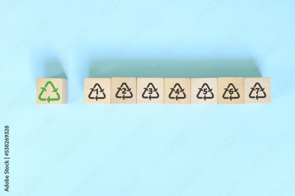 Recycling icon number 1 to 7 icon set symbol on wooden blocks flat lay.