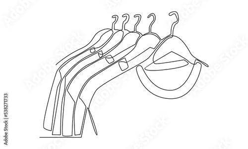 Continuous line of t-shirt hanging on clothing rack