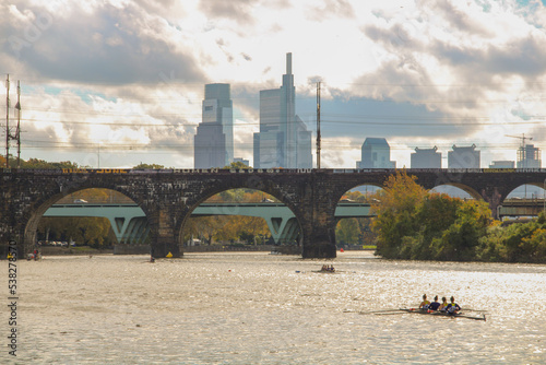 View of Schuylkill River with arch bridge and city buildings in the background. Philadelphia, USA.
