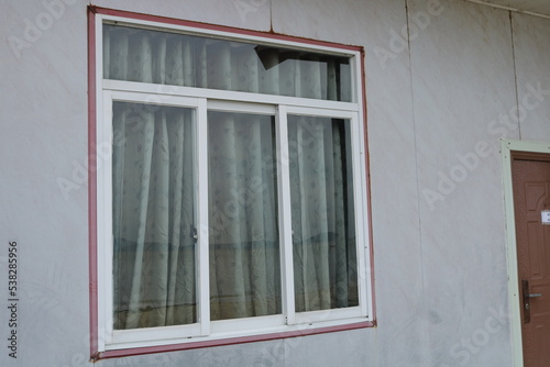 old window with shutters on the wall